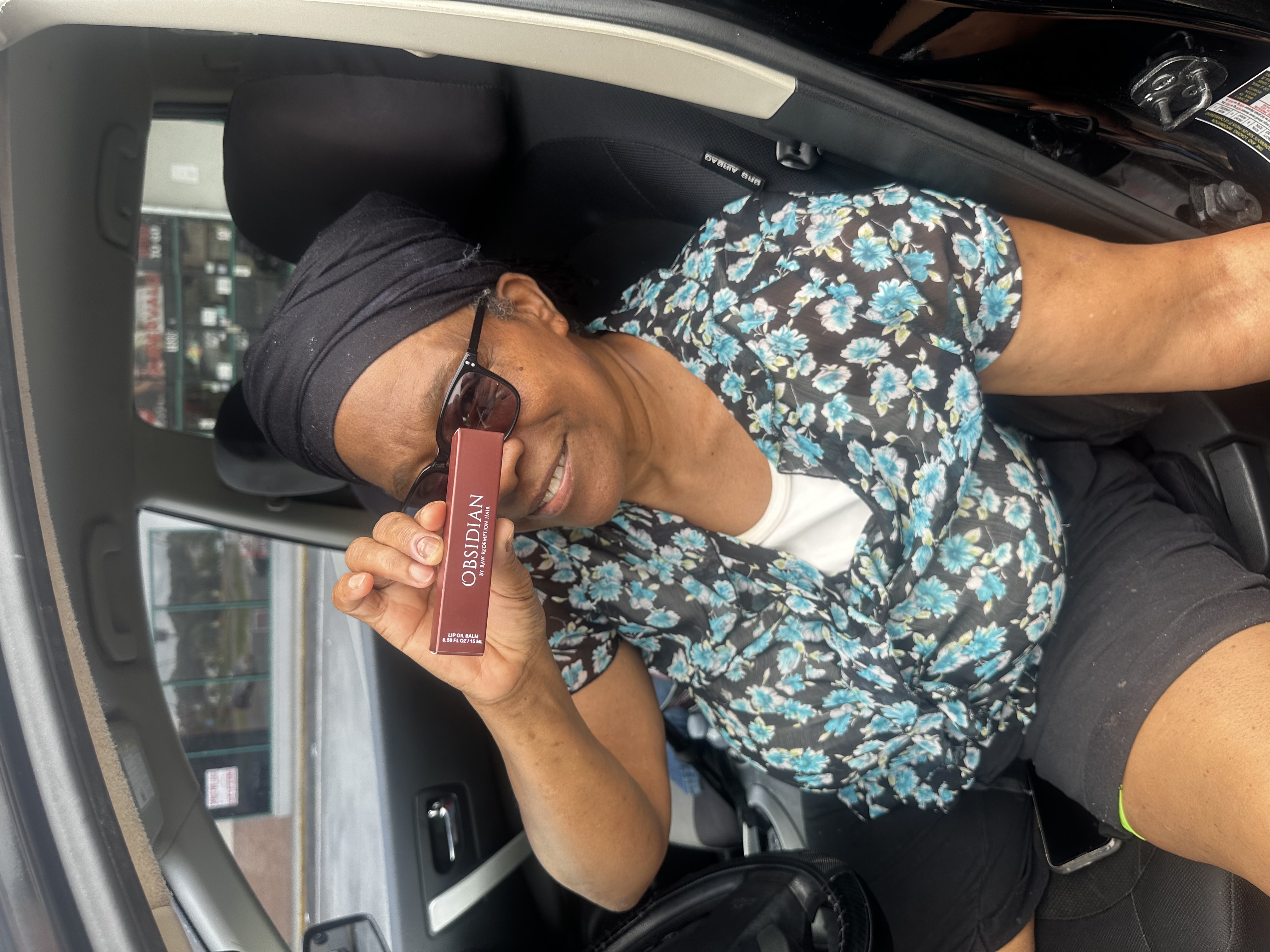 Supporter holding Obsidian Lip Oil